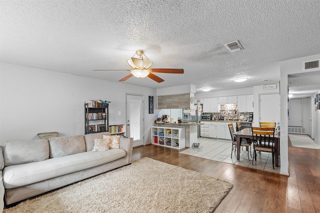 4212 Selina Ct, Arlington, TX 76016 - living area with a ceiling fan, hardwood / wood-style flooring, and a textured ceiling
