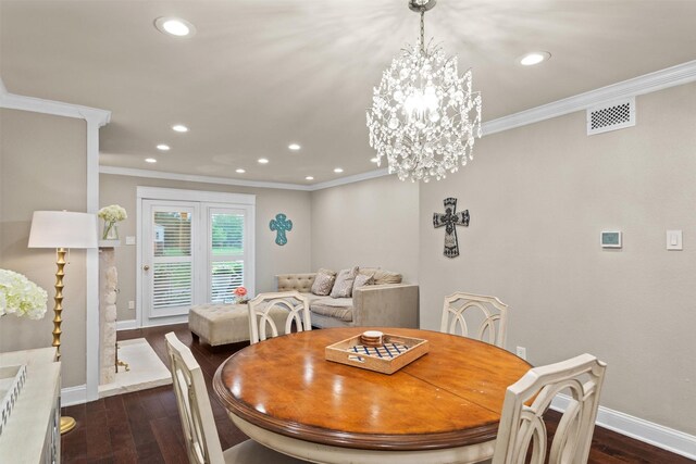 dining area with crown molding, baseboards, dark wood finished floors, and visible vents