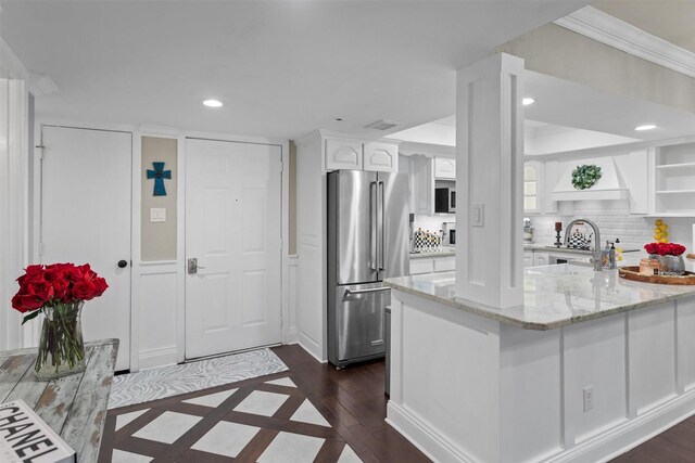kitchen featuring freestanding refrigerator, open shelves, recessed lighting, white cabinets, and light stone counters