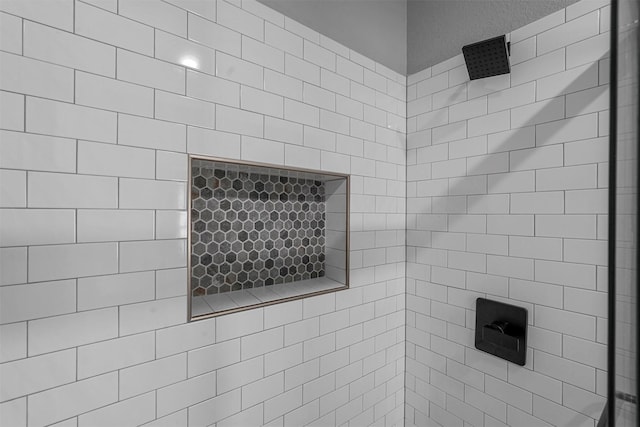 bathroom with a tile shower