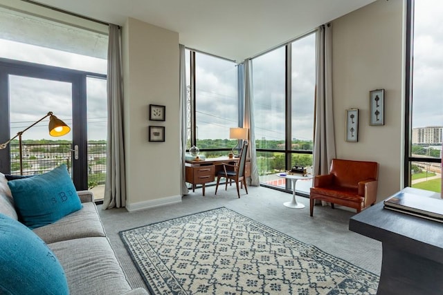 carpeted living room featuring floor to ceiling windows