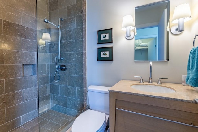 full bath featuring vanity, a walk in shower, and toilet