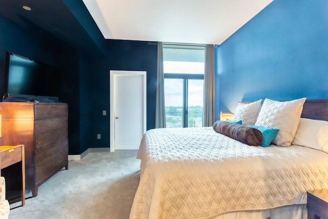 carpeted bedroom featuring baseboards