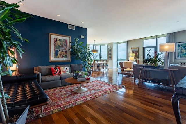 living area featuring visible vents, wood finished floors, and a wealth of natural light