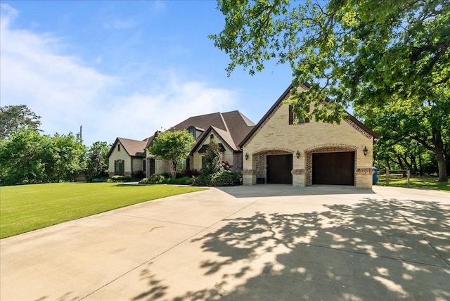 8230 County Road 530, Mansfield, TX 76063 - view of front of home featuring an attached garage, concrete driveway, a front lawn, and stone siding