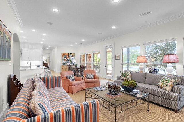 living area featuring recessed lighting, crown molding, and visible vents