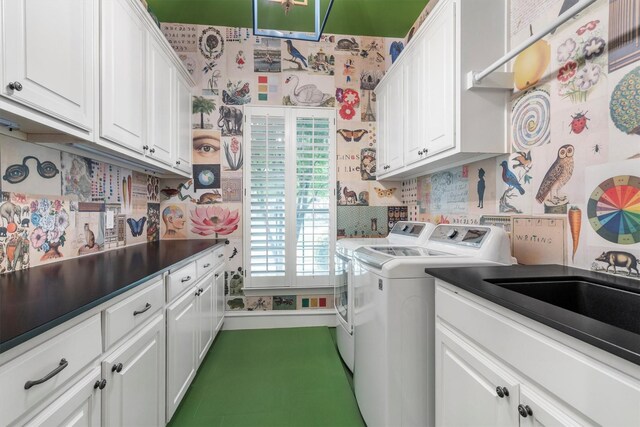 laundry area with a sink, washer and clothes dryer, cabinet space, and wallpapered walls