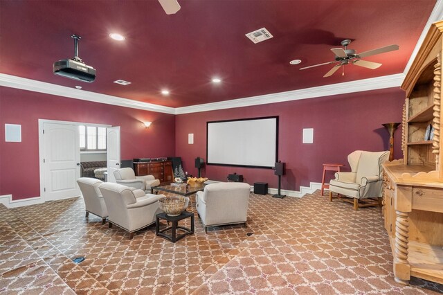 home theater with crown molding, baseboards, a ceiling fan, and visible vents
