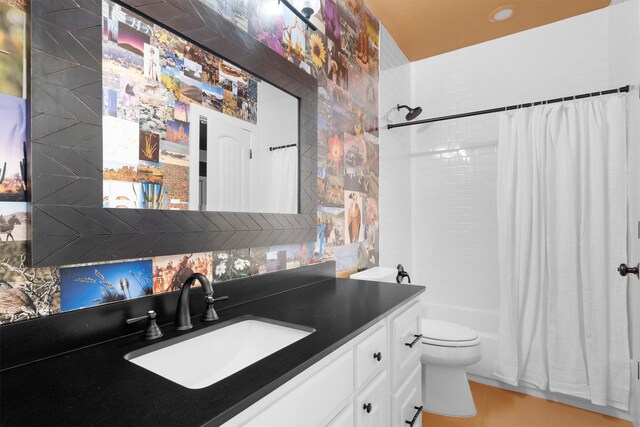 bathroom with toilet, shower / bath combination with curtain, and vanity