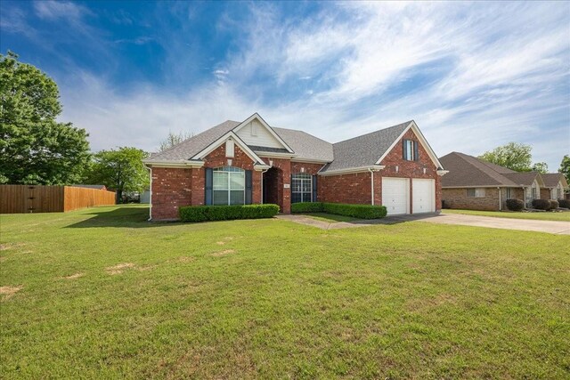 265 Old Spanish Trl, Valley View, TX 76272 - view of front of house featuring fence, a front yard, brick siding, a shingled roof, and driveway