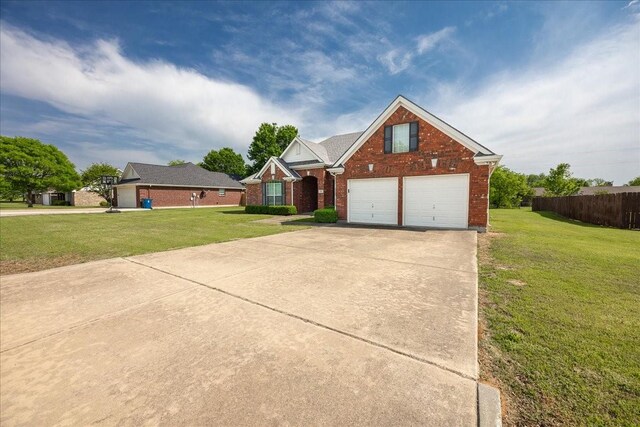 265 Old Spanish Trl, Valley View, TX 76272 - traditional home with a garage, a front lawn, and brick siding