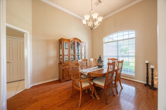 265 Old Spanish Trl, Valley View, TX 76272 - dining space featuring visible vents, baseboards, an inviting chandelier, ornamental molding, and light wood-style flooring