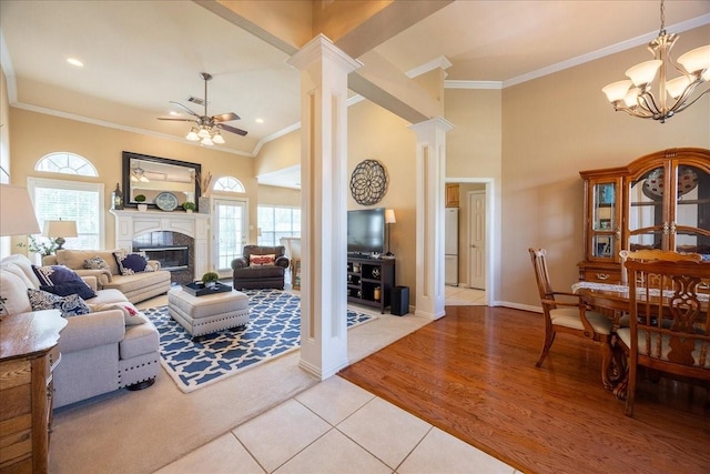 265 Old Spanish Trl, Valley View, TX 76272 - living area with crown molding, ornate columns, a glass covered fireplace, and light tile patterned flooring