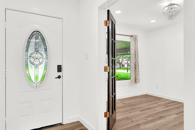 foyer featuring baseboards, recessed lighting, and wood finished floors