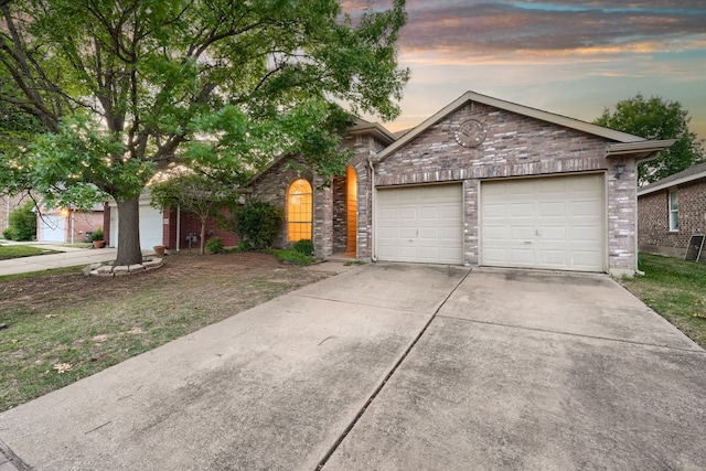 9104 Chesapeake Ln, Mckinney, TX 75071 - view of front of house featuring driveway, a garage, and brick siding
