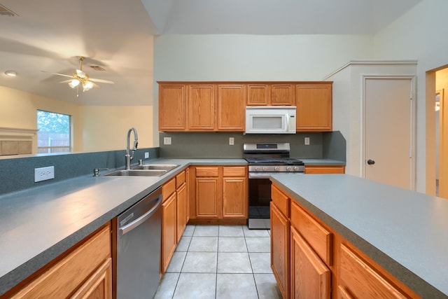 9104 Chesapeake Ln, Mckinney, TX 75071 - kitchen with appliances with stainless steel finishes, a sink, a ceiling fan, and light tile patterned flooring