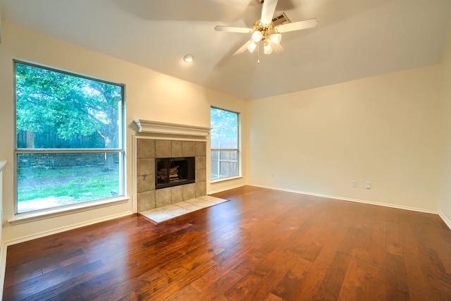 9104 Chesapeake Ln, Mckinney, TX 75071 - unfurnished living room featuring ceiling fan, wood finished floors, a fireplace, baseboards, and vaulted ceiling