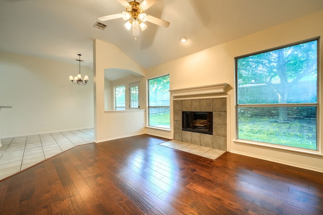 9104 Chesapeake Ln, Mckinney, TX 75071 - unfurnished living room with lofted ceiling, a fireplace, hardwood / wood-style floors, a ceiling fan, and a chandelier