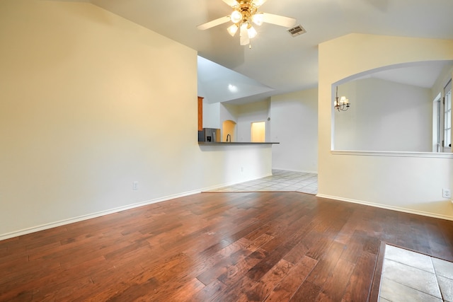9104 Chesapeake Ln, Mckinney, TX 75071 - spare room with lofted ceiling, hardwood / wood-style flooring, ceiling fan, arched walkways, and baseboards