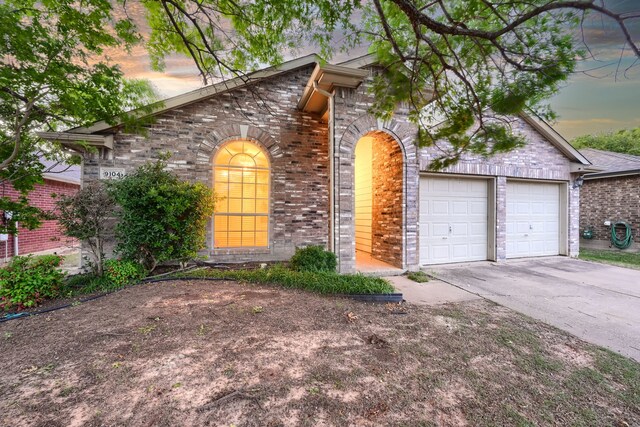 9104 Chesapeake Ln, Mckinney, TX 75071 - view of front of home with brick siding, driveway, and an attached garage