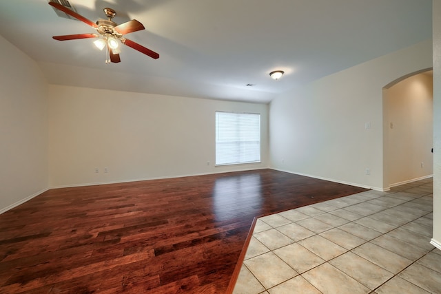 9104 Chesapeake Ln, Mckinney, TX 75071 - unfurnished room with arched walkways, light wood-type flooring, a ceiling fan, and baseboards