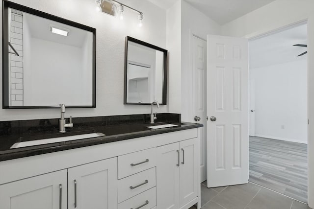 full bathroom featuring double vanity and a sink