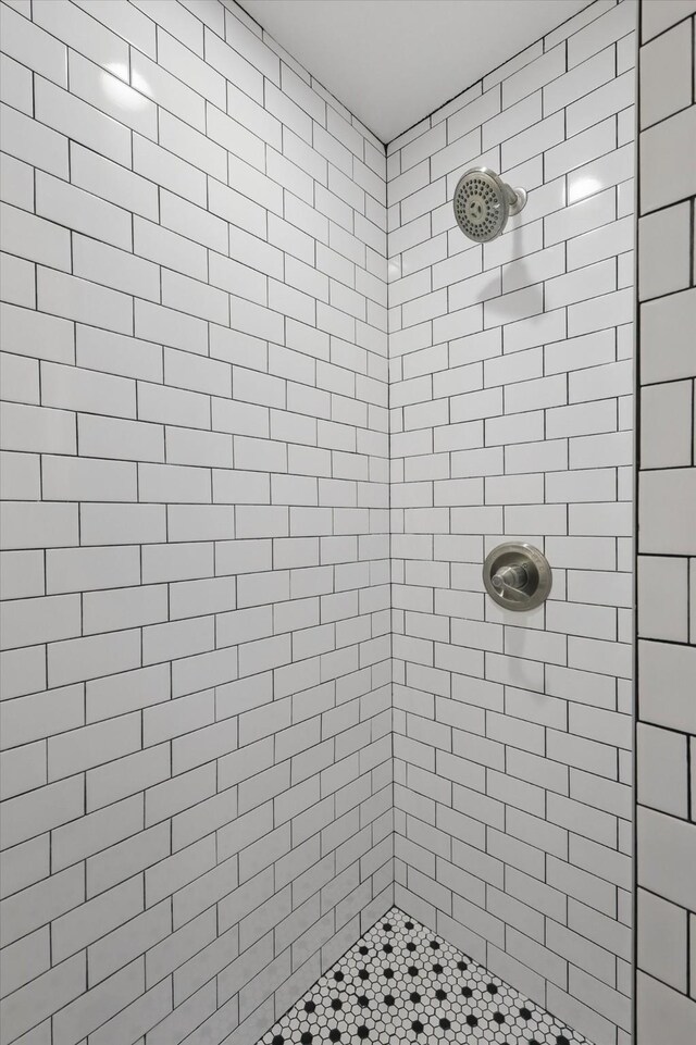 full bath with a tile shower