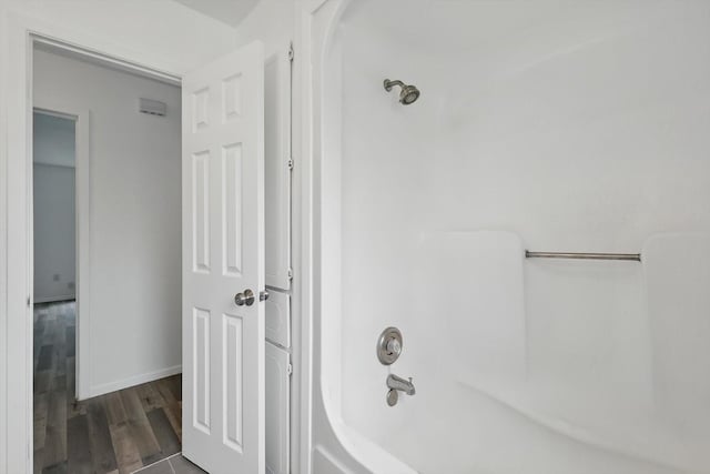 bathroom featuring baseboards and wood finished floors