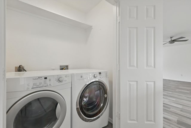 laundry room featuring laundry area, ceiling fan, wood finished floors, and washer and dryer