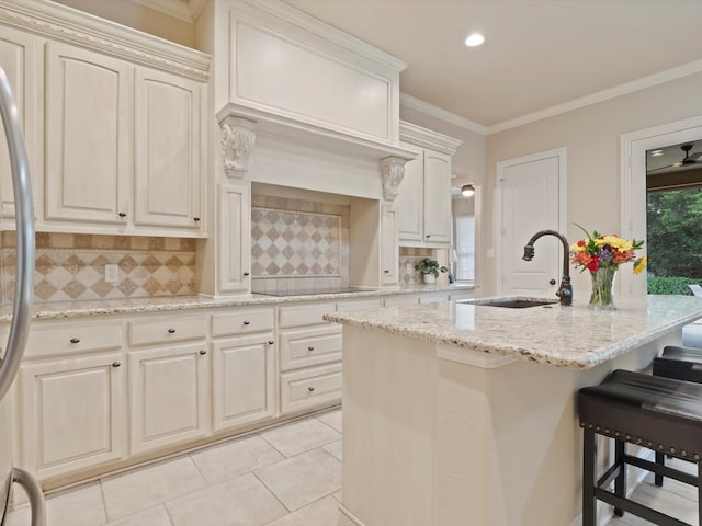10 Tennis Village Dr, Heath, TX 75032 - kitchen featuring a sink, black electric stovetop, tasteful backsplash, a breakfast bar area, and light stone counters