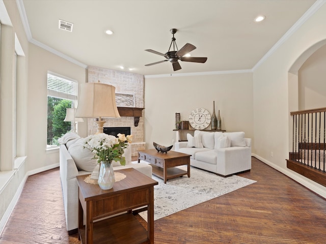 10 Tennis Village Dr, Heath, TX 75032 - living area featuring ceiling fan, dark wood finished floors, crown molding, a large fireplace, and arched walkways