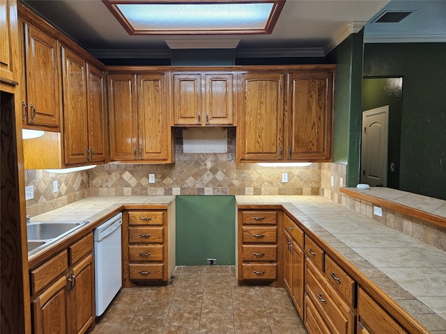 kitchen featuring brown cabinetry, ornamental molding, white dishwasher, tile countertops, and a sink