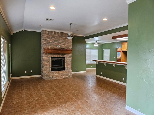 unfurnished living room with crown molding, ceiling fan, visible vents, and a fireplace