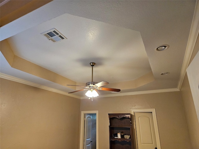 interior details featuring crown molding, a ceiling fan, recessed lighting, a tray ceiling, and visible vents