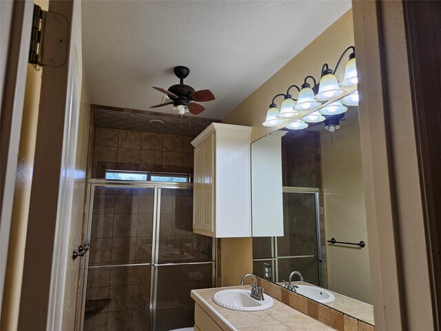 bathroom featuring vanity, ceiling fan, and a stall shower