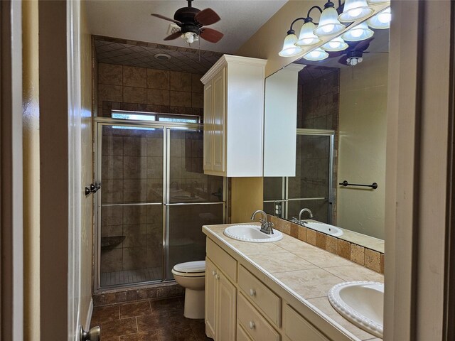bathroom with a sink, a stall shower, and toilet