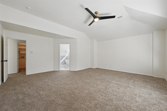 interior space featuring carpet floors, ceiling fan, visible vents, and lofted ceiling