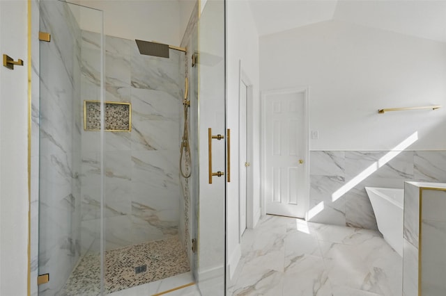 full bath featuring marble finish floor, a marble finish shower, vaulted ceiling, and a soaking tub