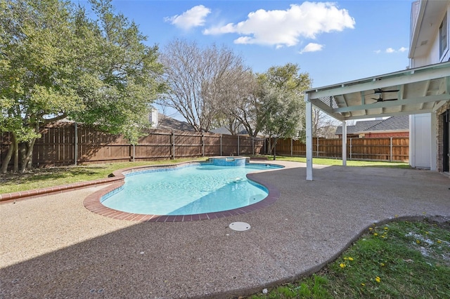 view of pool with a fenced backyard, a pool with connected hot tub, and a patio area