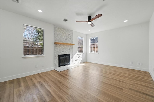 unfurnished living room with visible vents, recessed lighting, ceiling fan, and a large fireplace