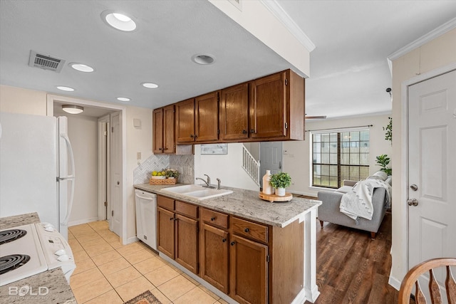 284 Settlers Park Dr, Shreveport, LA 71115 - kitchen featuring visible vents, a sink, brown cabinetry, and white appliances