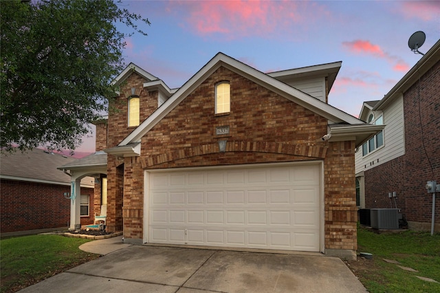 traditional-style home featuring concrete driveway, brick siding, an attached garage, and cooling unit