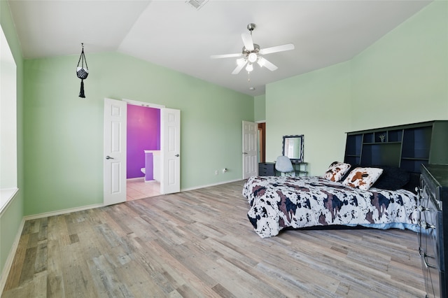 bedroom with baseboards, ceiling fan, wood finished floors, and lofted ceiling