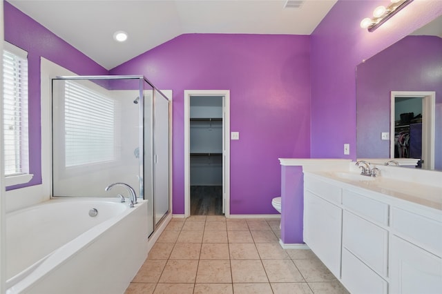 bathroom featuring tile patterned floors, a shower stall, lofted ceiling, and vanity