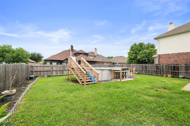 view of yard with a fenced backyard, a fenced in pool, and stairs