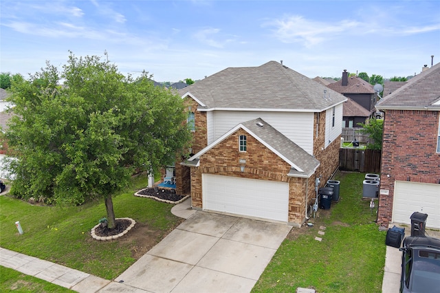 traditional-style home featuring driveway, a front yard, central air condition unit, brick siding, and a shingled roof