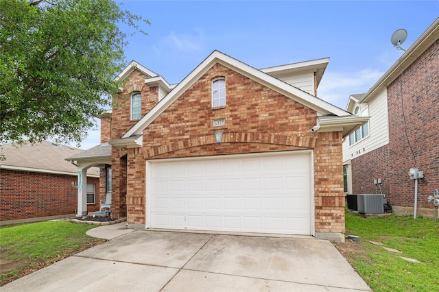 traditional-style house featuring brick siding, a garage, a front lawn, and concrete driveway
