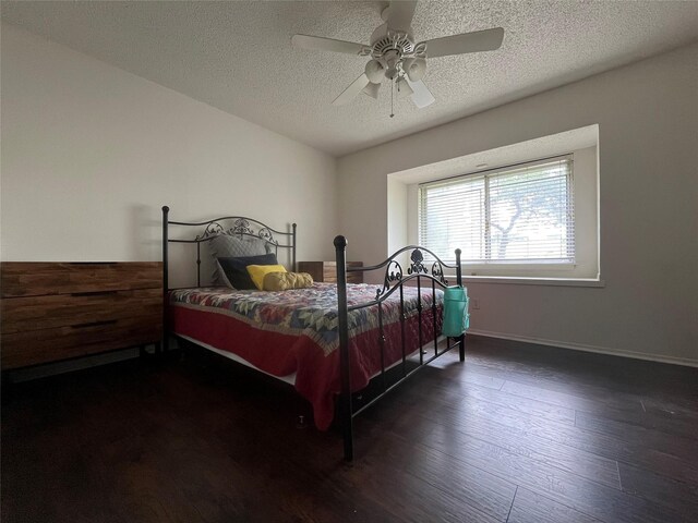 bedroom featuring baseboards, a ceiling fan, a textured ceiling, and wood finished floors