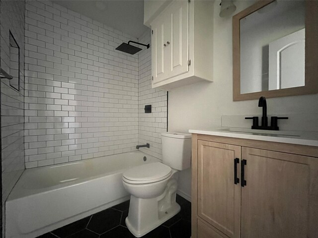 full bath featuring toilet, tile patterned floors, washtub / shower combination, and vanity