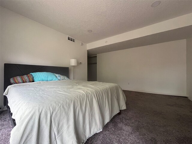 carpeted bedroom with a textured ceiling and visible vents